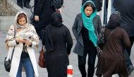 File photo Iranian women wearing hijab walk down a street in the capital Tehran on February 7, 2018. AFP / ATTA KENARE