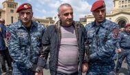 Armenian special police forces detain an opposition supporter during a demonstration called by opposition, held to protest former president's election as prime minister in central Yerevan on April 22, 2018.  AFP / Karen Minasyan

