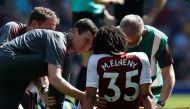 Arsenal's Egyptian midfielder Mohamed Elneny gets attention for an injury before being stretchered off during the English Premier League football match between Arsenal and West Ham United at the Emirates Stadium in London on April 22, 2018.   AFP / Ian KI