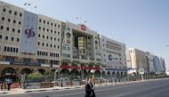 A man crosses Grand Hamad street where banks and financial institutions are located in Doha, Qatar. (Reuters) 