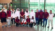The officials and players of team Qatar pose for a group photo.