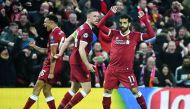 Liverpool's Egyptian midfielder Mohamed Salah (R) celebrates scoring their first goal during the UEFA Champions League first leg semi-final football match between Liverpool and Roma at Anfield stadium in Liverpool, north west England on April 24, 2018. AF