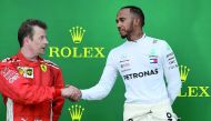 Race winner Mercedes’ British driver Lewis Hamilton (right) shakes hands with second-placed Ferrari’s Finnish driver Kimi Raikkonen as they celebrate on the podium of the Azerbaijan Grand Prix at the Baku City Circuit in Baku  yesterday. 