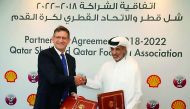 Sheikh Hamad bin Khalifa bin Ahmed Al Thani, the QFA President, and Andrew Faulkner, the Managing Director and Chairman of Qatar Shell Companies, shake hands during a sponsorship signing ceremony in Doha. 