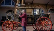 Senior Carriage Restorer, Martin Oates polishes the Scottish State Coach which will carry Britain's Prince Harry and wife Meghan Markle in wet weather along the processional route in Windsor following their marriage stands in the Royal Mews at Buckingham 