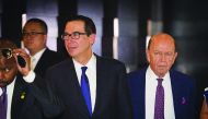 Commerce Secretary Wilbur Ross (R) walk through a hotel lobby as they head to the Diaoyutai State Guest House to meet Chinese officials for ongoing trade talks in Beijing on May 4, 2018. Top US and Chinese officials kicked off crucial trade talks on May 3