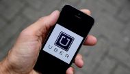 A photo illustration shows the Uber app logo displayed on a mobile telephone as it is held up for a posed photograph in central London, October 28, 2016. (Reuters / Toby Melville)