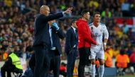 Real Madrid's Cristiano Ronaldo waits to return to the pitch after sustaining an injury as coach Zinedine Zidane gestures REUTERS/Albert Gea	
