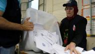 A Lebanese election official empties a ballot box after the polling station closed during Lebanon's parliamentary election, in Beirut, Lebanon, May 6, 2018. REUTERS/Mohamed Azakir