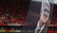 A large photograph of Arsenal's French manager Arsene Wenger is suspended from the roof as players take a lap of honour on the pitch after the English Premier League football match between Arsenal and Burnley at the Emirates Stadium in London on May 6, 20