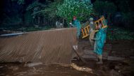 Volunteers search for survivers in a residential area after Patel dam burst its bank at Solai, about 40 kilometres north of Nakuru, Kenya, on May 10, 2018. AFP