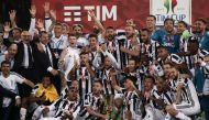 Juventus players pose with the trophy after winning the Italian Tim Cup (Coppa Italia) final Juventus vs AC Milan at the Olympic stadium on May 9, 2018 in Rome.   AFP / Isabella Bonotto
