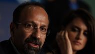 Iranian director Asghar Farhadi (L) speaks as Spanish actress Penelope Cruz listens during a press conference for the film 