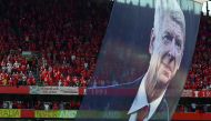 A large photograph of Arsenal's French manager Arsene Wenger is suspended from the roof as players take a lap of honour on the pitch after the English Premier League football match between Arsenal and Burnley at the Emirates Stadium in London on May 6, 20