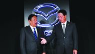 Mazda Motor Corp. outgoing President Masamichi Kogai (R) and next president Akira Marumoto shake hands at a news conference in Tokyo, Japan May 11, 2018. Reuters/Kim Kyung-Hoon