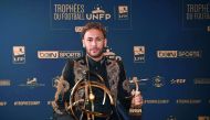 Paris Saint-Germain's Brazilian forward Neymar poses with his trophy after receiving the Best Ligue 1 Player award during a TV show on May 13, 2018 in Paris, as part of the 27th edition of the UNFP (French National Professional Football players Union) tro