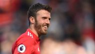 Manchester United's English midfielder Michael Carrick shares a joke at the end of the English Premier League football match between Manchester United and Watford at Old Trafford in Manchester, north west England, on May 13, 2018. AFP / Oli Scarff 