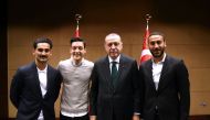Turkish President Recep Tayyip Erdogan(2nd R) posing for a photo with German football players Ilkay Gundogan (L), Mesut Ozil (L 2nd) and Turkish football player Cenk Tosun (R) in London.TURKISH PRESIDENTIAL PRESS OFFICE / KAYHAN OZER