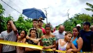 People look on near of the wreckage of a Boeing 737 plane that crashed in the agricultural area in Boyeros, around 20 km (12 miles) south of Havana, on Friday shortly after taking off from Havana's main airport in Cuba, May 18, 2018. Reuters/Alexandre Men