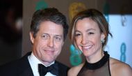 (FILES) In this file photo taken on February 12, 2017, British actor Hugh Grant (L) and Swedish producer Anna Eberstein (R) pose upon arrival at the BAFTA British Academy Film Awards at the Royal Albert Hall in London on February 12, 2017. AFP / Justin TA