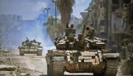 (FILE) Government forces head towards jihadist positions in the Hajar al-Aswad district on the southern outskirts of Damascus. May 14, 2018