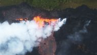Lava erupts and flows from a Kilauea volcano fissure, towards the Pacific Ocean, on Hawaii's Big Island on May 21, 2018 near Pahoa, Hawaii.  Mario Tama/Getty Images/AFP
