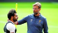 Liverpool manager Juergen Klopp (right) and Mohamed Salah during a training session at the  Liverpool Training in Anfield, Liverpool, Britain, yesterday.