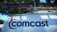 
In this file photo taken on April 25, 2018 a Comcast sign is seen on a truck in Miami, Florida. US cable operator Comcast said May 23, 2018 it is preparing an all-cash offer to beat out Disney for the purchase of 21st Century Fox assets up for sale.  AF