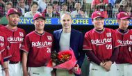 Spain midfielder Andres Iniesta, who signed for Japanese side Vissel Kobe, poses with Japan's professional baseball team Tohoku Rakuten Golden Eagles manager Masataka Nashida and players at Tokyo Dome in Tokyo, Japan, in this photo taken by Kyodo May 24, 