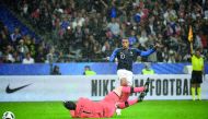 French forward Kylian Mbappe (R) shoots past Irish goalkeeper Colin Doyle during the friendly football match between France and Ireland at the Stade de France stadium, in Saint-Denis, on the outskirts of Paris, on May 28, 2018. The goal was not valid, Fre