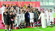 Al Sadd’s players and officials celebrate on the podium with the trophy after winning the 2017 Sheikh Jassim Cup at Al Duhail Stadium in this file photo.