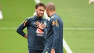 Brazil's striker Neymar (L) and Brazil's defender Miranda chat during a training session at Anfield stadium in Liverpool on June 2, 2018, ahead their International friendly football match against Croatia. / AFP / Oli SCARFF