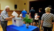 People vote at a polling station during the general election in Kamnik, Slovenia, June 3, 2018. REUTERS/Srdjan Zivulovic