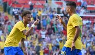Brazil's striker Roberto Firmino (R) celebrates with Brazil's striker Neymar after scoring their second goal during the International friendly football match between Brazil and Croatia at Anfield in Liverpool on June 3, 2018. Brazil won the game 2-0. (AFP
