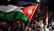 A protester holds up a Jordanian national flag during a protest in Amman, Jordan June 4, 2018. REUTERS/Muhammad Hamed
 