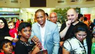 A child receives a gift from an official during the Garangao Night at an Ezdan Mall. 