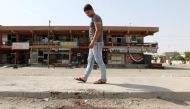 A man looks at bloodstains on a roadway after a bomb explosion in the ethnically-mixed Iraqi oil city of Kirkuk, Iraq, June 9, 2018. REUTERS/Ako Rasheed
