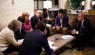 Canada's Prime Minister Justin Trudeau and G7 leaders France's President Emmanuel Macron, Germany's Chancellor Angela Merkel, Britain's Prime Minister Theresa May and U.S. President Donald Trump hold a meeting with staff on the first day of the G7 meeting