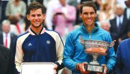 Spain's Rafael Nadal (R) poses with the Mousquetaires Cup (The Musketeers) after his victory, next to second placed Austria's Dominic Thiem, after their men's singles final match, on day fifteen of The Roland Garros 2018 French Open tennis tournament in P