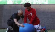 Egypt's forward Mohamed Salah exercises his shoulder during a training session at the Akhmat Arena stadium in Grozny on June 12, 2018, ahead of the Russia 2018 World Cup football tournament. / AFP / KARIM JAAFAR