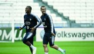 French national players Antoine Griezman (R) and Djibril Sidibe run during a training session, on June 8, 2018, at the Groupama Stadium in Decines-Charpieu near Lyon, central-eastern France, on the eve of the international friendly football match against 