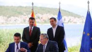 Greek Foreign Minister Nikos Kotzias and his Macedonian counterpart Nikola Dimitrov sign an accord to settle a long dispute over the former Yugoslav republic's name as Greek Prime Minister Alexis Tsipras and Macedonian Prime Minister Zoran Zaev look on in