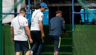 Brazil's forward Neymar (R) leaves the practice with team physio Bruno Mazziotti (L) and team Doctor Rodrigo Lasmar (C) during a training session of Brazil national football team at Yug Sport Stadium, in Sochi, on June 19, 2018, ahead of the Russia 2018 W