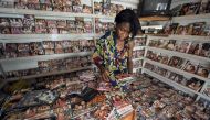 (FILES) In this file photo taken on March 29, 2010 a sales girl sorts through dvds in a shop at the Nigerian film market in Lagos. AFP / Pius Utomi EKPEI