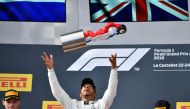 Winner Mercedes' British driver Lewis Hamilton (C) celebrates on the podium next to second placed Red Bull Racing's Dutch driver Max Verstappen (L) and third placed Ferrari's Finnish driver Kimi Raikkonen (R) after the Formula One Grand Prix de France at 