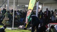 Injured people lie on the ground after an explosion at the stadium in Bulawayo where Zimbabwe President just addressed a rally on June 23, 2018. AFP / KEN MAUR / DO NOT USE ON TWITTER
