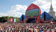 ( FILE PHOTO ) Russia and Uruguay's fans watch on a giant screen the Russia 2018 World Cup Group A football match between Uruguay and Russia, at the fan zone in Moscow on June 25, 2018. / AFP / Maxim ZMEYEV
