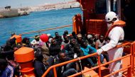 Migrants intercepted aboard dinghies off the coast in the Strait of Gibraltar, sit on a rescue boat upon arrival at the port of Tarifa, southern Spain July 1, 2018. REUTERS/Jon Nazca

