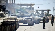 Syrian government tanks and soldiers taking position in the town of Western Ghariyah, about 15 kilometres east of the southern embattled city of Daraa. / AFP / SANA