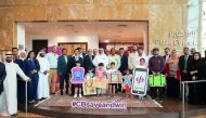 Commercial Bank officials with some of the April and May draw winners of ‘Save & Win’ campaign, at the bank headquarters, in West Bay.